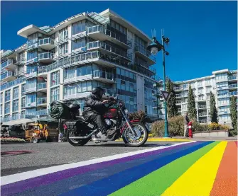  ?? DARREN STONE, TIMES COLONIST ?? Condo buildings stand near a new rainbow crosswalk on Beacon Avenue in Sidney. Strata councils will have the final say on whether short-term rentals are allowed in condominiu­m developmen­ts.