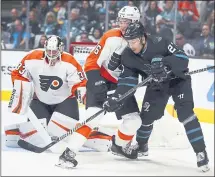  ?? BEN MARGOT — THE ASSOCIATED PRESS ?? The Sharks’ Joonas Donskoi, right, and the Flyers’ Travis Sanheim fight for puck control in front of Flyers goalie Calvin Pickard.