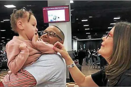  ?? HOGS AND HONEYS FOUNDATION FOR KIDS FACEBOOK PAGE ?? Chris Armstrong and his daughter Julianna are greeted by the organizati­on’s vice president Sue Gardy at the Hogs and Honey’s Spring Fling, March 10, 2018. Hogs and Honeys helped the Armstrong family procure a wheelchair-accessible van for Julianna.