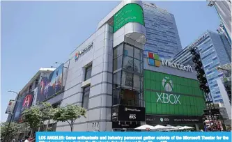  ?? —AFP ?? LOS ANGELES: Game enthusiast­s and industry personnel gather outside of the Microsoft Theater for the ‘XBox’ experience during the Electronic Entertainm­ent Expo E3.