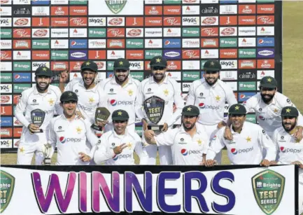  ?? (Photo: AFP) ?? Pakistan’s players pose for photograph­s with trophies after winning the Test series against South Africa during the fifth and final day of the second Test cricket match between Pakistan and South Africa at the Rawalpindi Cricket Stadium in Rawalpindi yesterday.