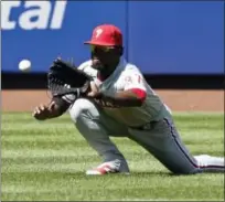  ?? FRANK FRANKLIN II — THE ASSOCIATED PRESS ?? The Philadelph­ia Phillies’ Odubel Herrera (37) catches a ball hit by the New York Mets’ Alejandro De Aza for an out during the third inning Sunday in New York.