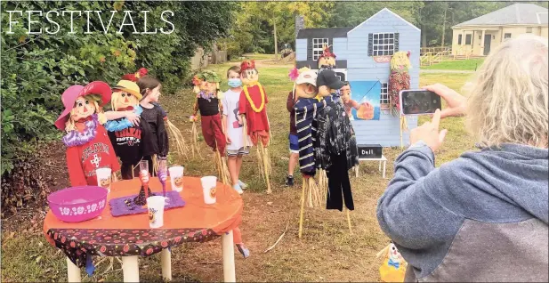  ?? Joe Amarante / Hearst Connecticu­t Media ?? Children mingle with scarecrows during a photo op at the 25th annual Scarecrows Along Main Street in Wethersfie­ld on Oct. 12.