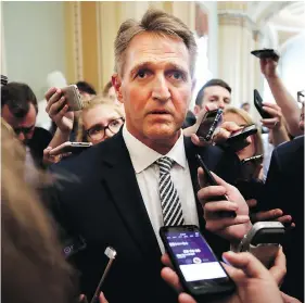  ?? JACQUELYN MARTIN/THE ASSOCIATED PRESS ?? Sen. Jeff Flake is questioned by reporters about Supreme Court nominee Brett Kavanaugh on Capitol Hill on Friday.