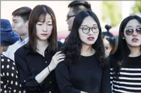  ?? ALEXANDRA WIMLEY/CHICAGO TRIBUNE FILE PHOTOGRAPH ?? Students comfort each other outside of the U.S. Courthouse on July 3, 2017 in Urbana, Ill., before the bond hearing for Brendt Christense­n, who allegedly kidnapped visiting scholar Yingying Zhang.