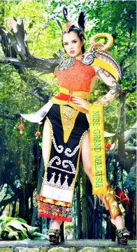  ??  ?? Debra in the national costume inspired by Sarawak.