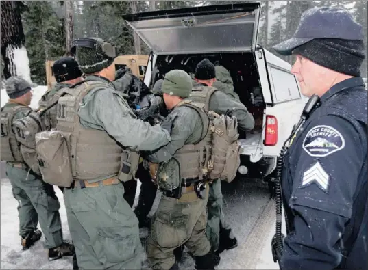  ?? PICTURE: AP ?? NO ROUTE TO ESCAPE: FBI SWAT team members load the body of Benjamin Colton Barnes into a vehicle yesterday, at the Mount Rainier National Park in Washington state. Barnes’s body was recovered from a creek bed yesterday after he allegedly shot and...