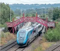  ?? CHRIS MILNER ?? TransPenni­ne Class 802 No. 802204 passes through Ravensthor­pe station on August 14, 2020. The station will move 300 yards to behind the vantage point and the line will be electrifie­d. Earthworks for the grade separation, realignmen­t and flyover for the diverted lines from Wakefield (on the right) will take place on the footprint of the existing station site. Hopefully a suitable home can be found for the footbridge.