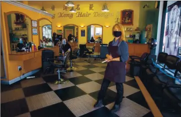  ?? PHOTO BY RAY CHAVEZ — STAFF PHOTOGRAPH­ER ?? Hong Kong Hair Salon owner Julia Lam waits for clients at her salon in South San Francisco on March 12. Since the closures began last March, she has lost 70% of her business. Lam suspects they’ve gone to neighborin­g counties.