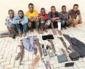  ?? Suspected Boko Haram members accused of the bomb blasts in Nyanya and Kuje with the killing of several police officers, including the seven at Galadimawa Roundabout in Abuja, during their parade by the police in Abuja. On the left is Umar Abdulmalik, an a ??