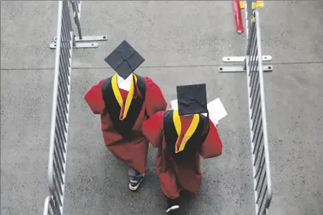  ?? SETH WENIG/AP ?? NEW GRADUATES WALK INTO THE HIGH POINT SOLUTIONS STADIUM before the start of the Rutgers University graduation ceremony in Piscataway Township, N.J., on May 13, 2018. The Supreme Court is about to hear arguments over President Joe Biden’s student debt relief plan. It’s a plan that impacts millions of borrowers who could see their loans wiped away or reduced.