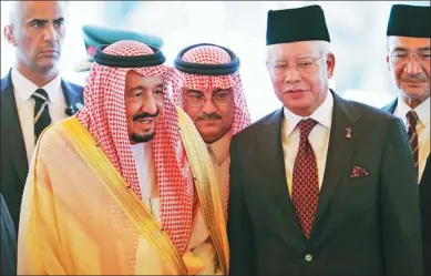  ?? ASSOCIATED PRESS ?? Saudi Arabia’s King Salman (left) stands next to Malaysian Prime Minister Najib Razak after inspecting an honor guard during a welcoming ceremony at Parliament House in Kuala Lumpur, Malaysia, on Sunday,