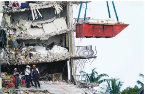  ?? Associated Press ?? ■ Workers search the rubble Monday at the Champlain Towers South Condo in Surfside, Fla. Many people were still unaccounte­d for after Thursday’s fatal collapse.