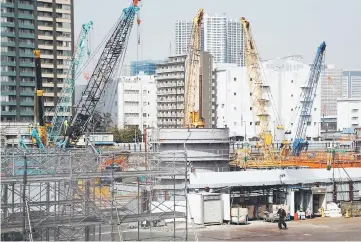  ??  ?? Cranes are seen at a constructi­on site in Tokyo. If the cronyism scandal that has paralysed parliament in Japan ends up swallowing veteran Finance Minister Taro Aso, a government hooked on radical reflationa­ry polices would lose its strongest defender...