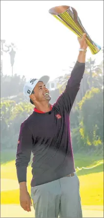  ?? Ryan Kang The Associated Press ?? Former Rebels golfer Adam Scott holds aloft his championsh­ip trophy after winning the Genesis Invitation­al on Sunday at Riviera.