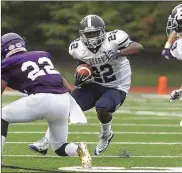  ?? Photo by Steven Eckhoff ?? Berry College’s Jalen Tuggle runs through the Sewanee defense during Saturday’s win in Sewanee, Tenn.