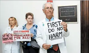  ?? MANUEL BALCE CENETA/AP PHOTOS ?? Retired physician Jay Brock joins others protesting the GOP health care bill Monday outside the office of Senate Majority Leader Mitch McConnell, right.