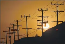  ?? Patrick T. Fallon AFP/Getty Images ?? “EXTREME heat is straining the state energy grid. Power interrupti­ons may occur unless you take action,” read an emergency alert sent Tuesday.