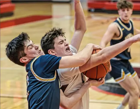  ?? For the Post-Gazette ?? A TOUGH SPOT Beaver’s Aiden Townsend, right, has his shot blocked by Norwin’s Trent Raspotnik in a tournament game Wednesday at Peters Township. Beaver defeated Norwin, 60-52.