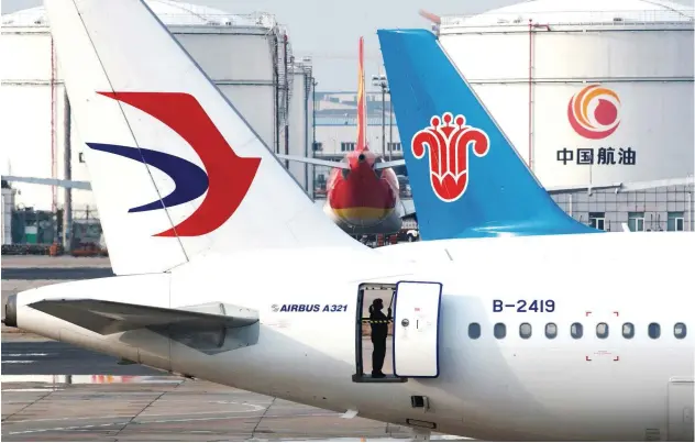  ?? Reuters ?? An employee cleans an aircraft at Beijing Airport in China.