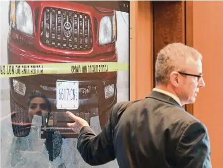  ?? Tyler Sizemore/Hearst Connecticu­t Media ?? Retired Connecticu­t State Police Sgt. Matthew Reilly shows a photograph of the red Toyota Tacoma seized by police on day 14 of Michelle Troconis' criminal trial at state Superior Court in Stamford on Wednesday. Troconis is on trial for charges related to the disappeara­nce and death of New Canaan resident Jennifer Dulos.