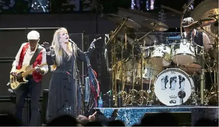  ??  ?? (From left) John McVie, Nicks and Fleetwood perform onstage with Fleetwood Mac at a recent concert in Washington. — AP