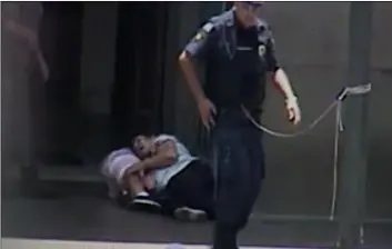  ??  ?? In this frame grab taken from a security camera provided by Campinas City Hall, two people shot by a gunman lie wounded at the entrance of the Metropolit­an Cathedral, in Campinas, Brazil, on Tuesday. CamPInas CIty Hall VIa aP