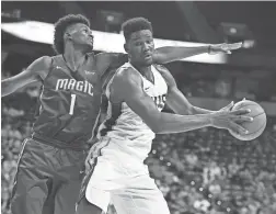  ?? GETTY IMAGES ?? Suns rookie center Deandre Ayton is guarded by the Magic’s Jonathan Isaac during a Summer League game at the Thomas & Mack Center in Las Vegas on Monday. Ayton scored 17 points and had 13 rebounds in the Suns’ 71-53 win.
