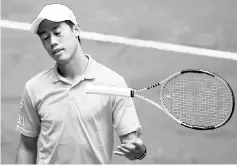  ??  ?? Kei Nishikori drops his racket during his match against Spanish player David Ferrer at the ATP Madrid Open in Madrid in this May 11 file photo. — AFP photo