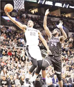  ?? (AP) ?? San Antonio Spurs forward Rudy Gay (22) scores past Sacramento Kings forward JaKarr Sampson (29) during the second half of an NBA basketball game on April 9, in San Antonio.