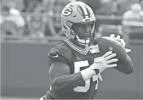  ?? MARK HOFFMAN / MILWAUKEE JOURNAL SENTINEL ?? Packers linebacker Kamal Martin handles the ball during a drill in training camp.