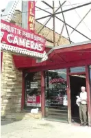  ??  ?? Joe Herbert under the neon sign at his shop, Marquette Photo Supply, 3314 W. 63rd.