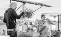  ?? NETFLIX ?? Alfonso Cuarón, the film’s writer and director, and Yalitza Aparicio, who plays Cleo, on the set of ‘‘Roma.’’