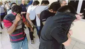  ?? PIC BY ROSDAN WAHID ?? Some of the suspects being led to the Selayang magistrate’s court yesterday.