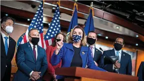  ??  ?? Speaker’s fury: Nancy Pelosi addresses media flanked by impeachmen­t managers
