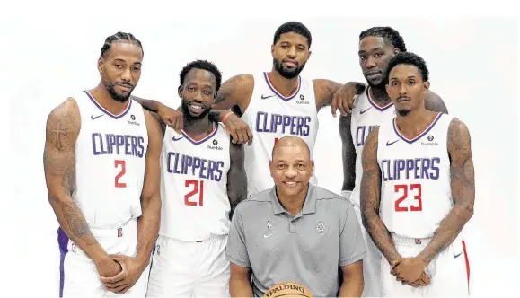 ?? Josh Lefkowitz / Getty Images ?? Kawhi Leonard (2) and Paul George, center, are the high-profile additions that have made coach Doc Rivers’ Clippers solid championsh­ip contenders.