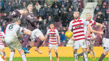  ??  ?? Craig Halkett pounces to head home Hearts’ late equaliser