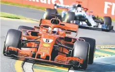  ?? — AFP photo ?? Ferrari’s German driver Sebastian Vettel (front) leads Mercedes’ British driver Lewis Hamilton during the Formula One Australian Grand Prix in Melbourne.