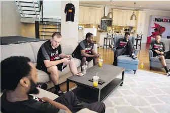  ?? THE CANADIAN PRESS ?? Raptors Uprising GC Kenneth Hailey, left, Christophe­r Doyle, Seanquai Harris, Yusuf Abdulla and Joshua McKenna in the living room of their Bell Fibe House in Toronto.