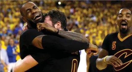  ?? EZRA SHAW, GETTY IMAGES ?? LeBron James, left, and Kevin Love of the Cavaliers hug after defeating Golden State in Game 7 of the NBA final. LeBron won his third NBA final MVP award.