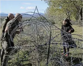  ?? /Reuters ?? Split village: Valia Valishvili, 88, who lives on the side of the village controlled by the Russian-backed authoritie­s in South Ossetia, is visited by activist David Katsarava in Khurvaleti, Georgia.