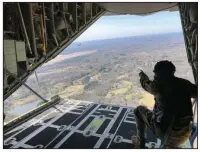  ?? (Arkansas Democrat-Gazette/Tony Holt) ?? Chief Master Sgt. Donald Tarrance with the 327th Airlift Squadron rides in the back of a C-130J during a training exercise Saturday in Central Arkansas. More photos at arkansason­line.com/38flight/.