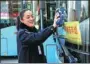  ?? ZHU LIXIN / CHINA DAILY ?? Driver Yang Miaomiao, in Bengbu, Anhui province, a delegate to the 19th CPC National Congress, cleans her bus in November.