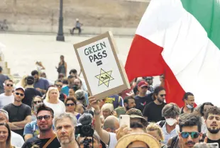  ??  ?? People gather to protest against the COVID-19 vaccinatio­n pass in Rome, Italy, July 27, 2021.