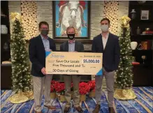  ?? PHOTO PROVIDED ?? Saratoga Casino Hotel general manager Alex Tucker, left, and Sam Gerrity, vice president of business developmen­t for Saratoga Casino Hotel, right, present a $5,000check to Saratoga County Chamber of Commerce president Todd Shimkus, center, for the chamber’s Save Our Locals campaign. It was the first donation of Saratoga Casino Hotel’s 30Days of Giving campaign.