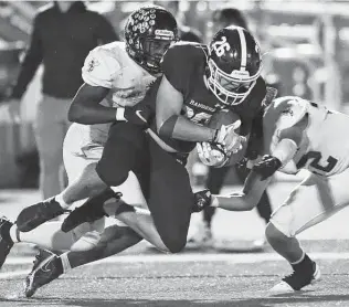  ?? Photos by Kin Man Hui / Staff photograph­er ?? Smithson Valley's Doug Lantz (26) tries to get past East Central's Treshawn Johnson, left, and Elijah Simons as he nears the end zone during the third quarter. He scored on the next play.