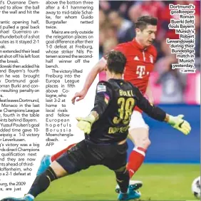  ?? AFPPIX ?? Dortmund’s goalkeeper Roman Buerki (left) fouls Bayern Munich’s Robert Lewandowsk­i during their Bundesliga match in Munich yesterday. – Simeone’s patience pays off Even Ronaldo can have an off day Oblak is one of the finest in the world