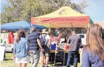  ?? COURTESY OF THE TOWN OF BERNALILLO ?? Mountain West Brew Fest attendees wait their turn to sample beers from Bernalillo’s Kaktus Brewing Co. at a past event.