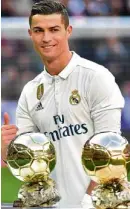  ?? —AFP ?? Ronaldo with two of his four Ballon d’Or trophies.