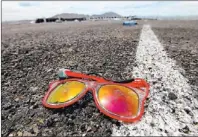  ?? JESSICA EBELHAR/ LAS VEGAS REVIEW-JOURNAL ?? This discarded pair of sunglasses saw more than 115,000 revelers attend the Electric Daisy Carnival at the Las Vegas Speedway.